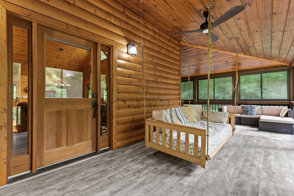 220 Solar Drive Blue Ridge, GA 30513 - Photo 26 of 59 a view of a porch with furniture and floor to ceiling window