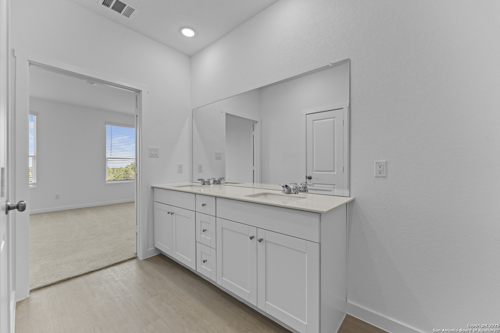 14926 Taradeau San Antonio, TX 78254 - Photo 11 of 25 a bathroom with 2 sink and a mirror