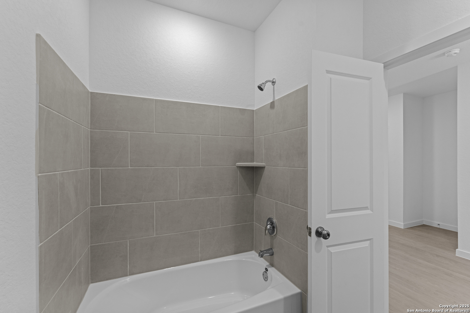 14926 Taradeau San Antonio, TX 78254 - Photo 18 of 25 a bathroom with a bathtub and a shower