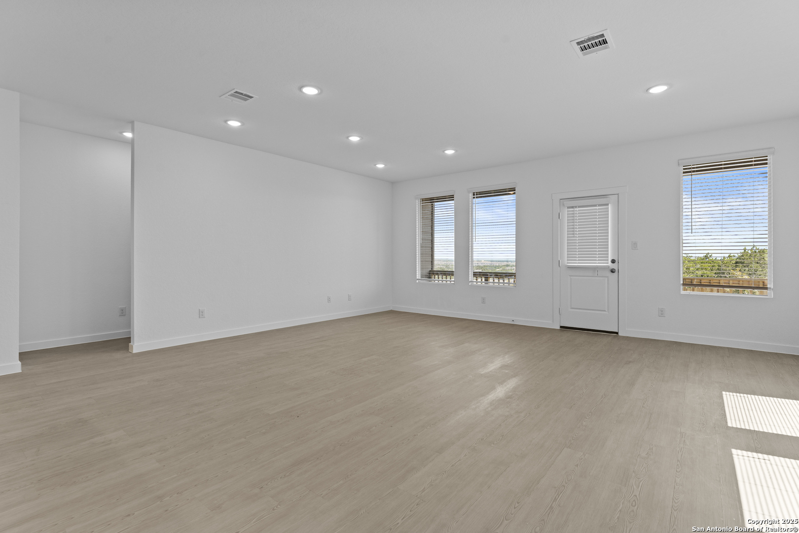 14926 Taradeau San Antonio, TX 78254 - Photo 4 of 25 an empty room with windows and pillars in it