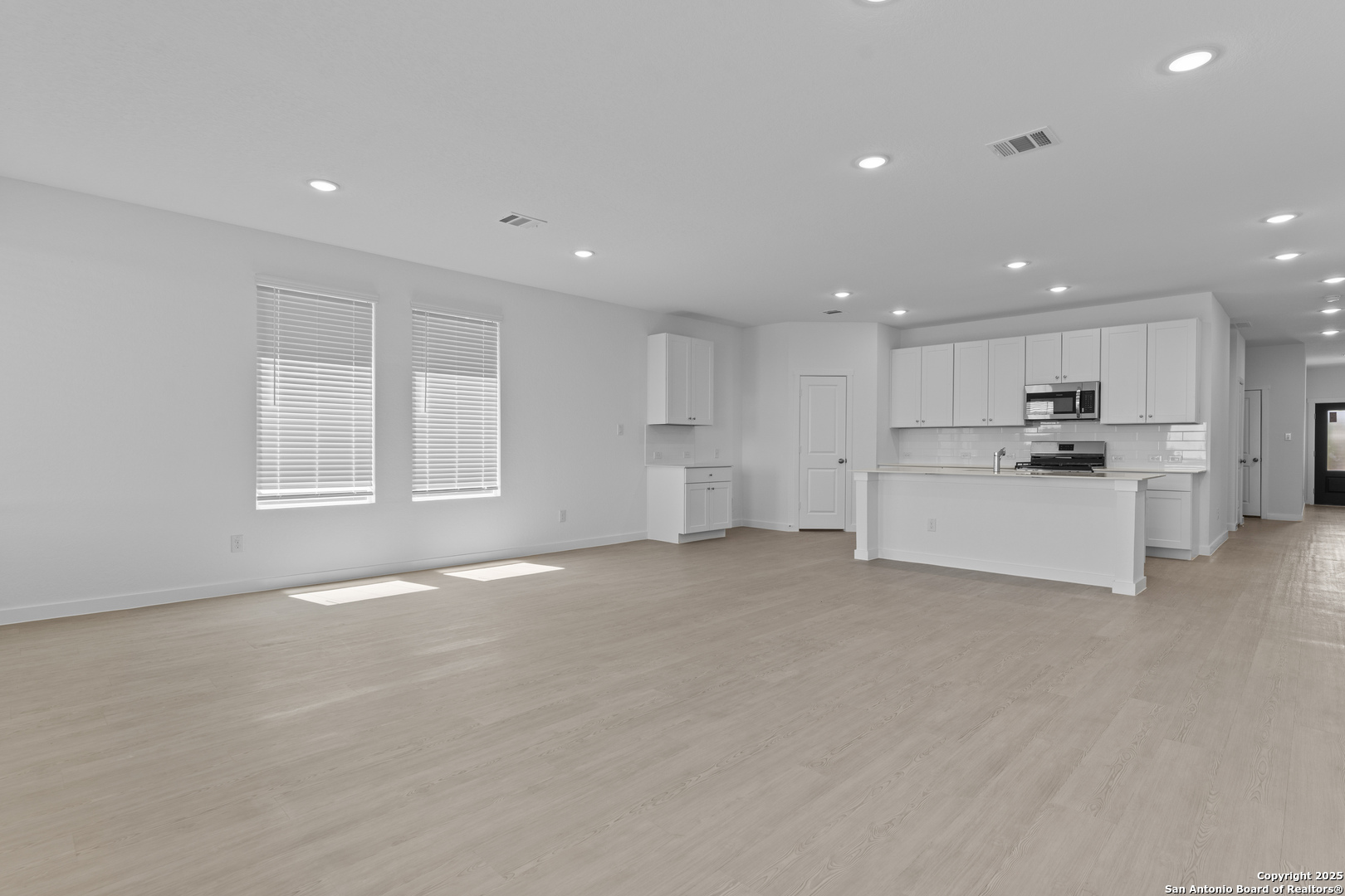 14926 Taradeau San Antonio, TX 78254 - Photo 7 of 25 a view of an empty room with stainless steel appliances wooden floor and a window