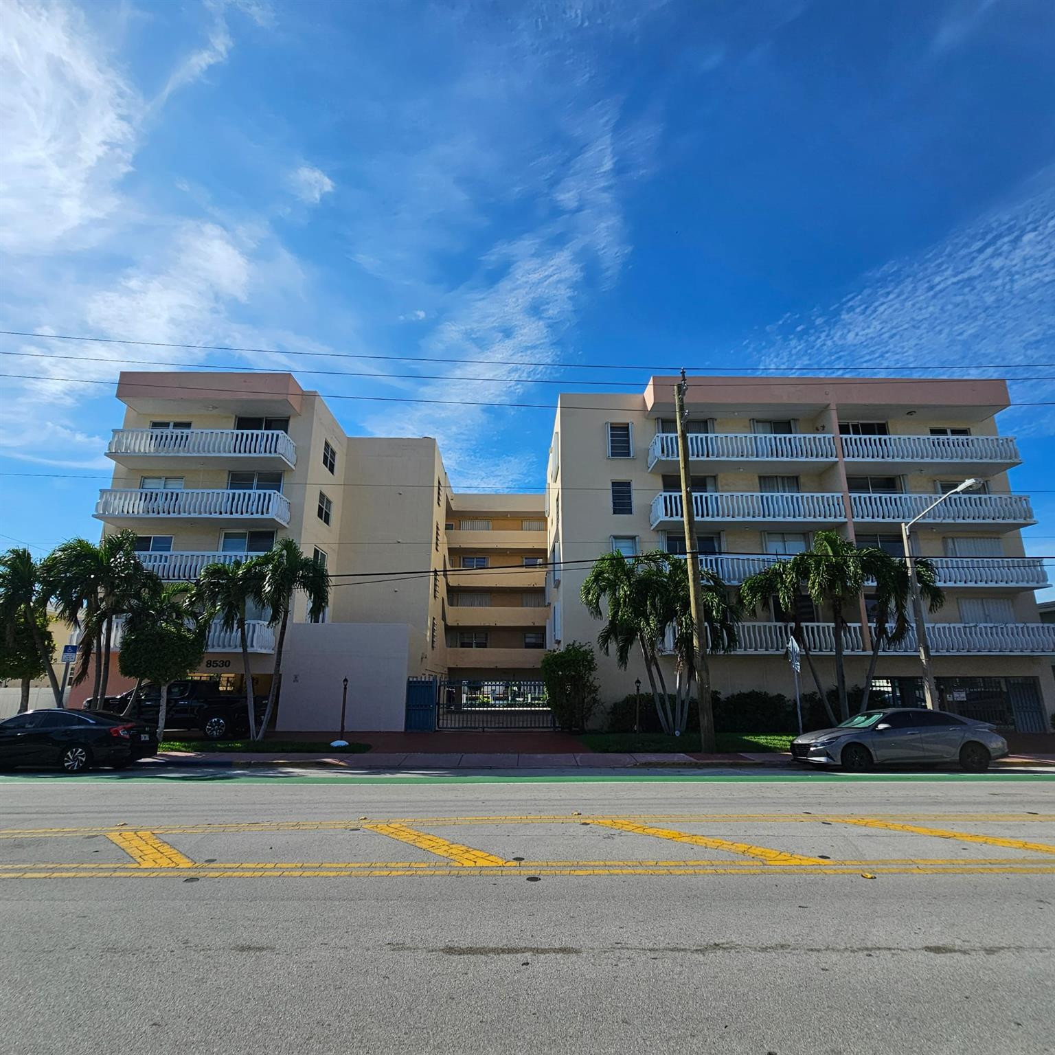 8530 Byron Avenue, Unit 406 Miami Beach, FL 33141 - Photo 1 of 35 a view of a building with a backyard and a garden