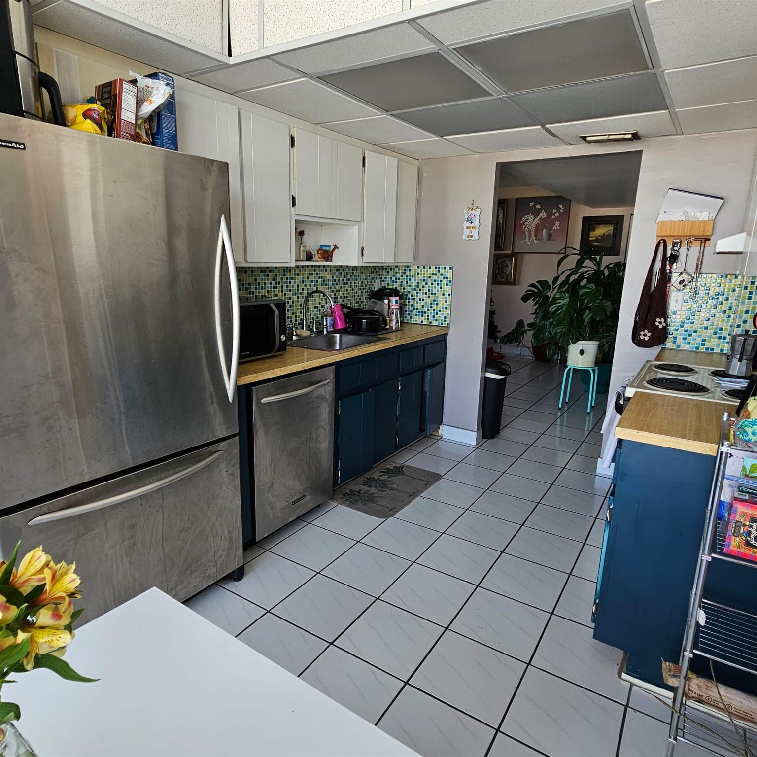 8530 Byron Avenue, Unit 406 Miami Beach, FL 33141 - Photo 14 of 35 a kitchen with stainless steel appliances a refrigerator sink and cabinets