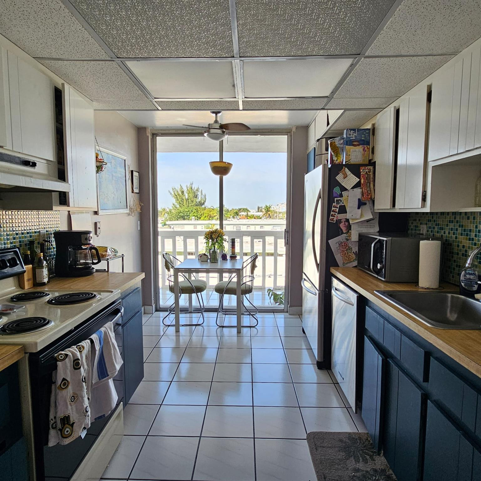 8530 Byron Avenue, Unit 406 Miami Beach, FL 33141 - Photo 15 of 35 a kitchen with granite countertop a sink a counter top space appliances and cabinets