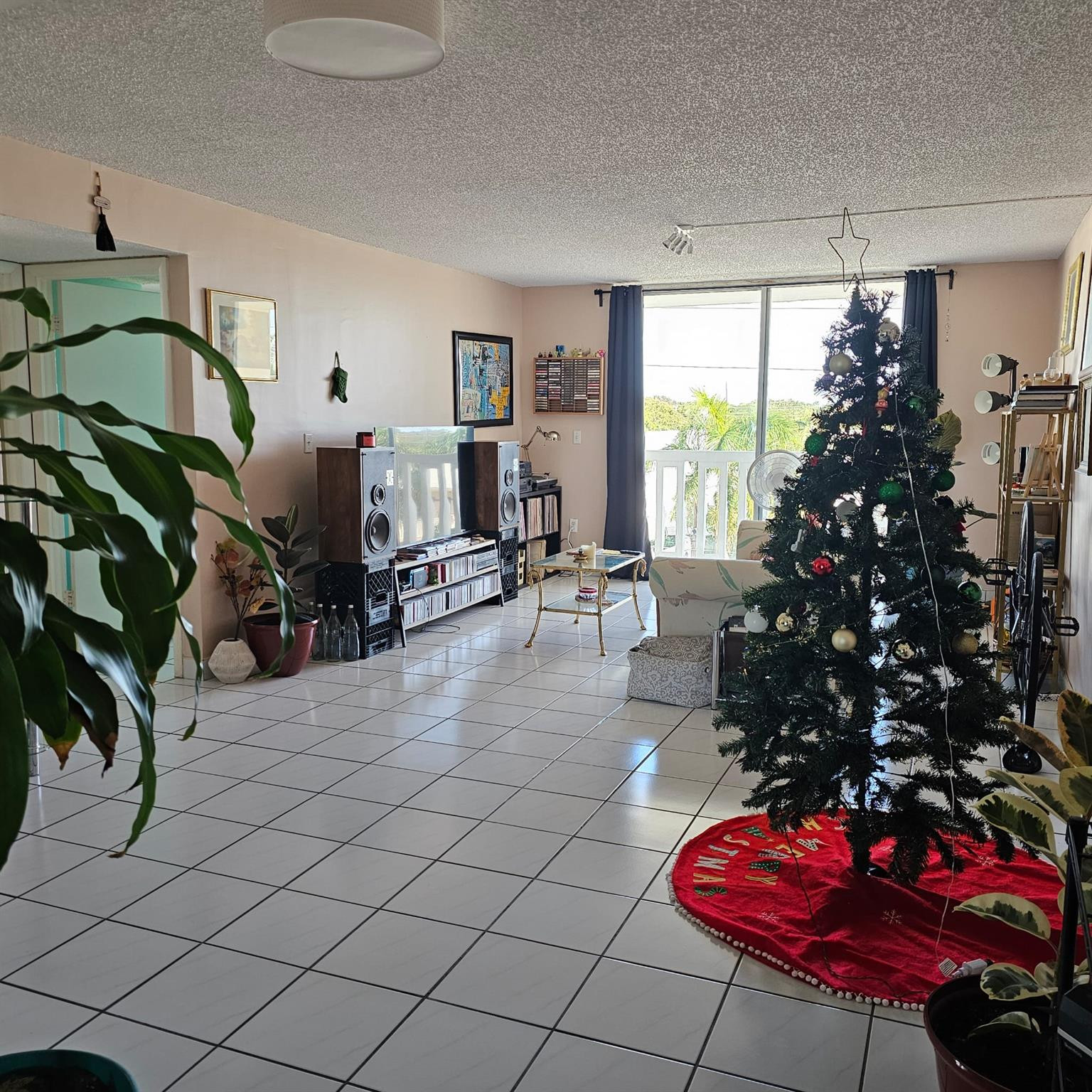 8530 Byron Avenue, Unit 406 Miami Beach, FL 33141 - Photo 24 of 35 a living room with furniture a flowers and a potted plant