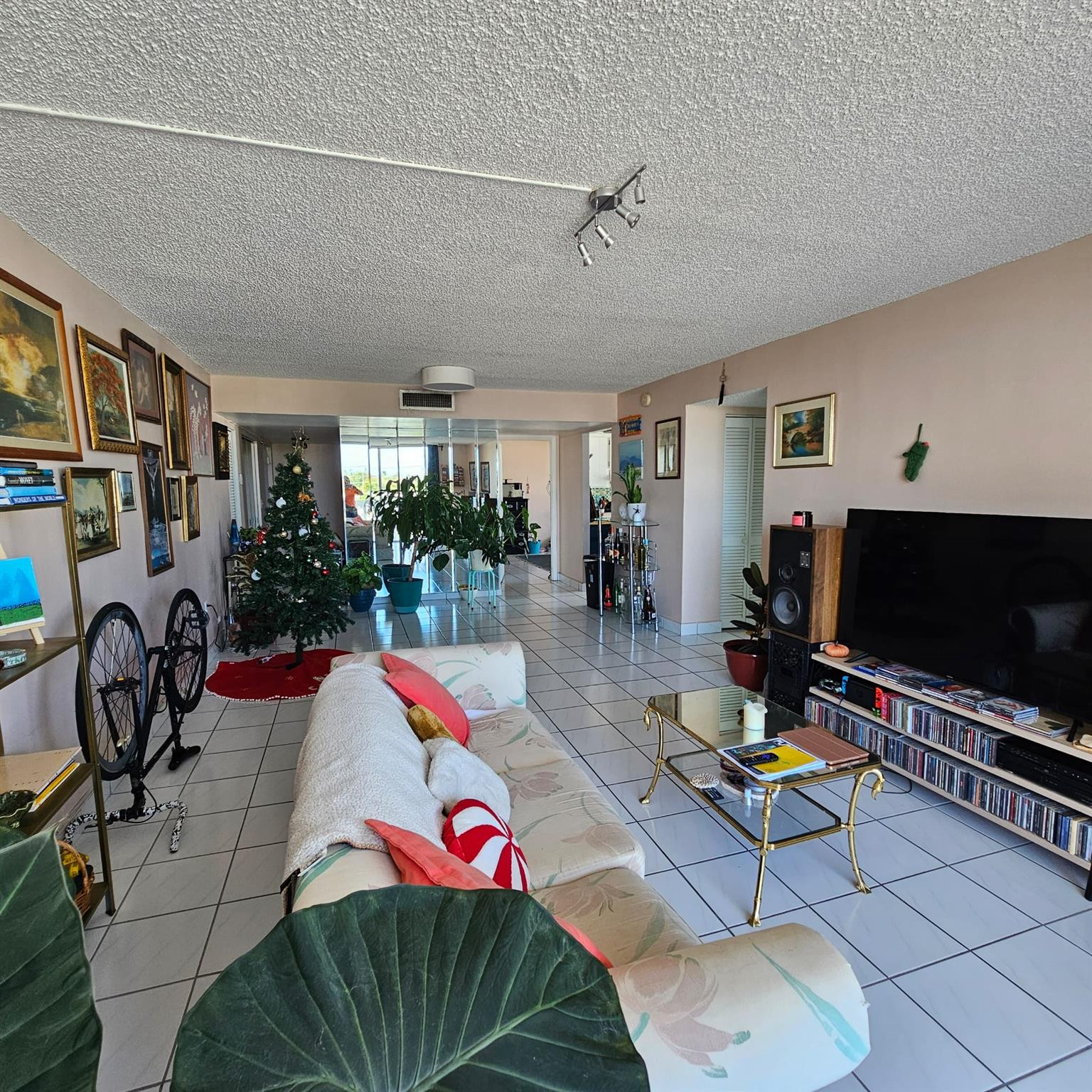 8530 Byron Avenue, Unit 406 Miami Beach, FL 33141 - Photo 27 of 35 a living room with lots of furniture and a flat screen tv