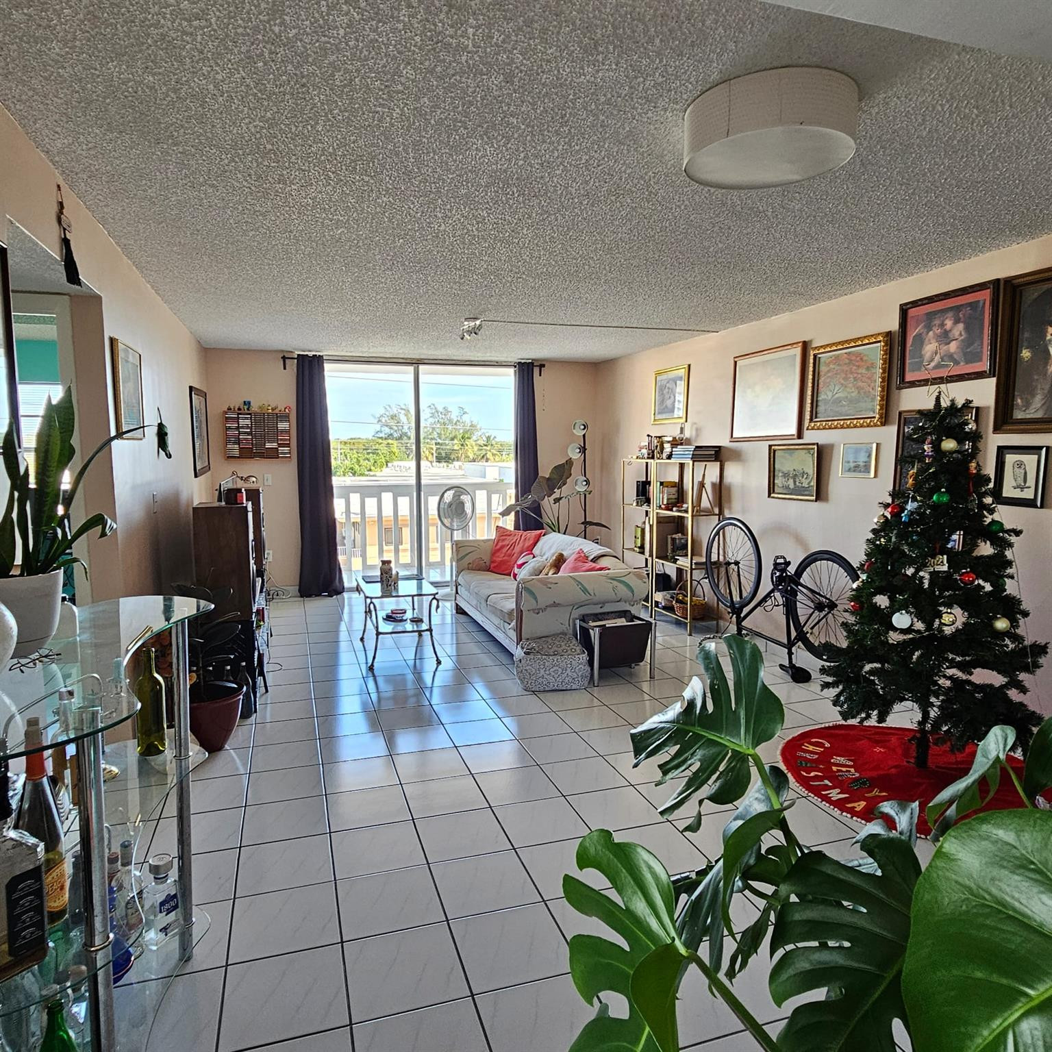 8530 Byron Avenue, Unit 406 Miami Beach, FL 33141 - Photo 4 of 35 a living room with furniture a chandelier and a window