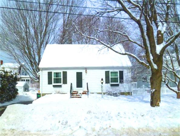 a view of a house with a yard covered in snow