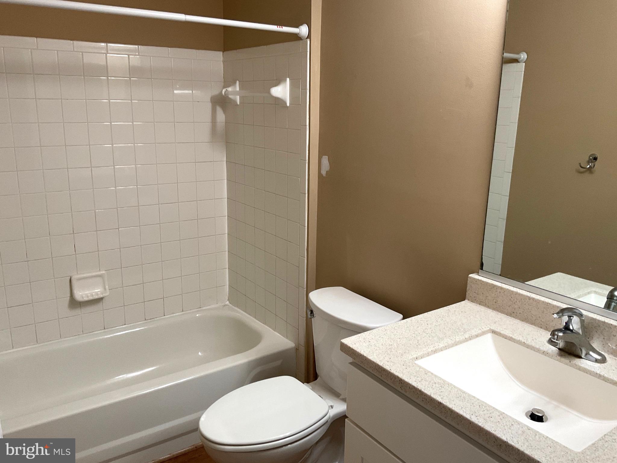 2152 Bristol Drive, Unit 4 Frederick, MD 21702 - Photo 8 of 12 a bathroom with a sink a toilet and shower