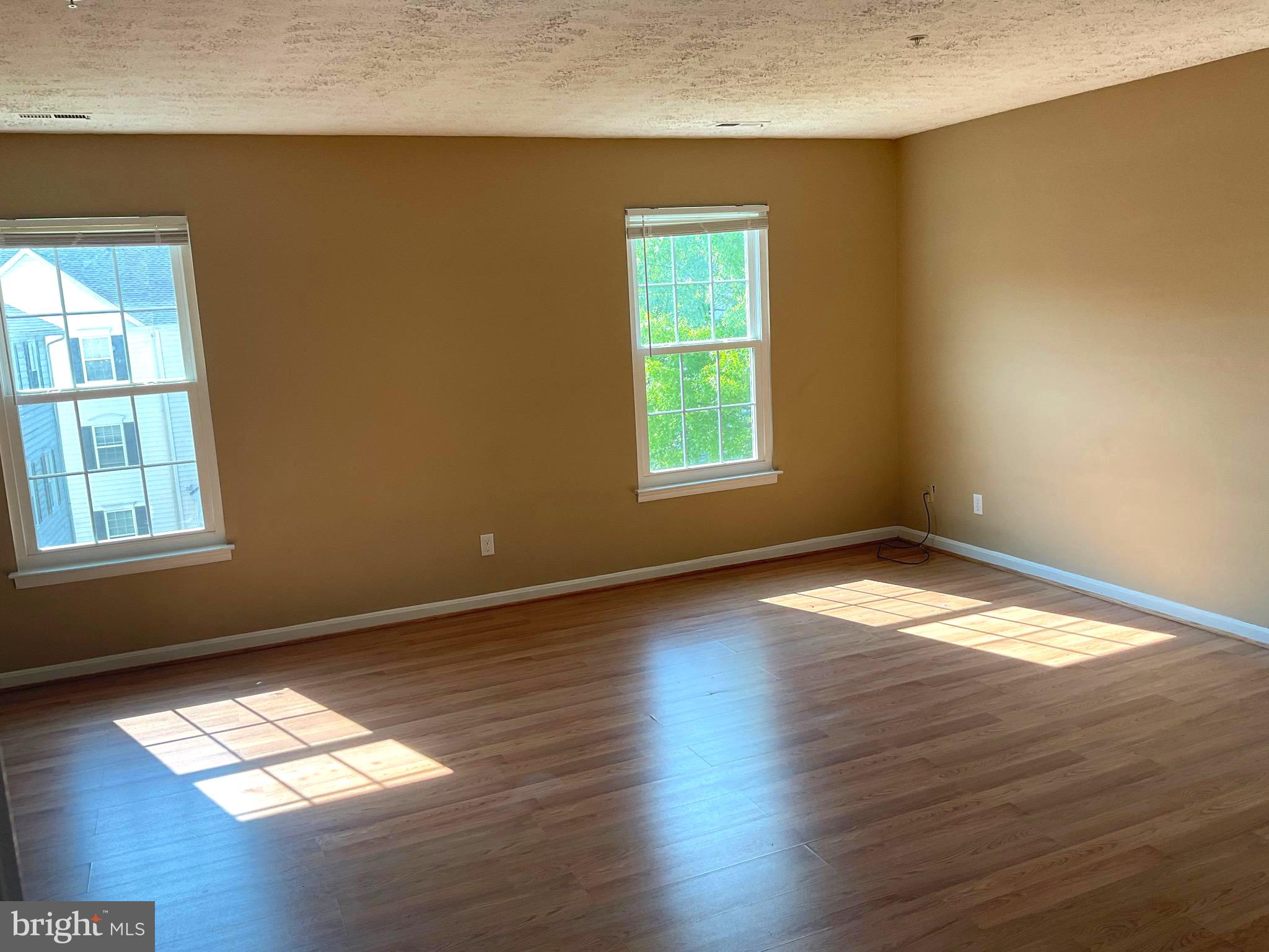 2152 Bristol Drive, Unit 4 Frederick, MD 21702 - Photo 10 of 12 an empty room with wooden floor and windows