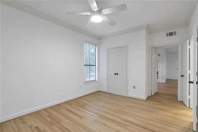 a view of an empty room and wooden floor