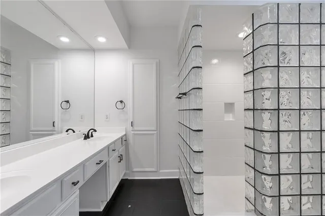 a bathroom with a double vanity sink and a mirror
