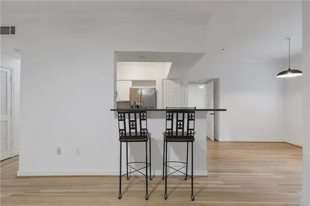 a view of a room with wooden floor and windows