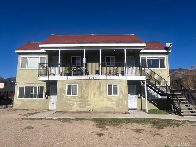 a view of a white house with large windows