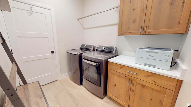 1127 4240 North Enoch, UT 84721 - Photo 28 of 56 Laundry room featuring cabinet space, washing machine and clothes dryer, and light tile patterned floors