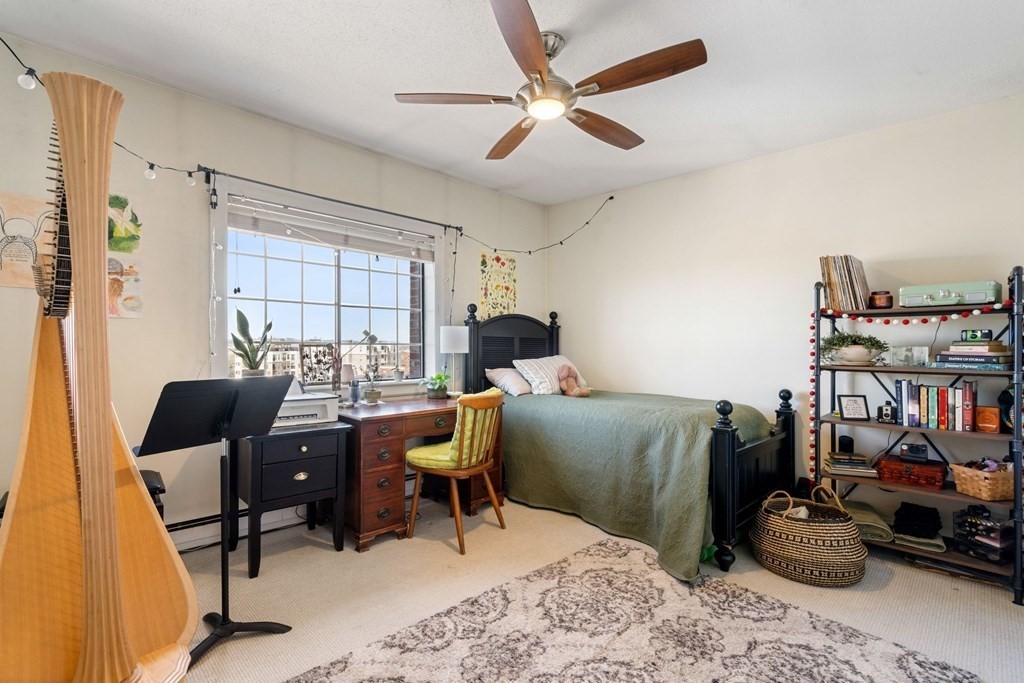 474 Broadway, Unit 49 Somerville, MA 02145 - Photo 11 of 19 a room with furniture and a window
