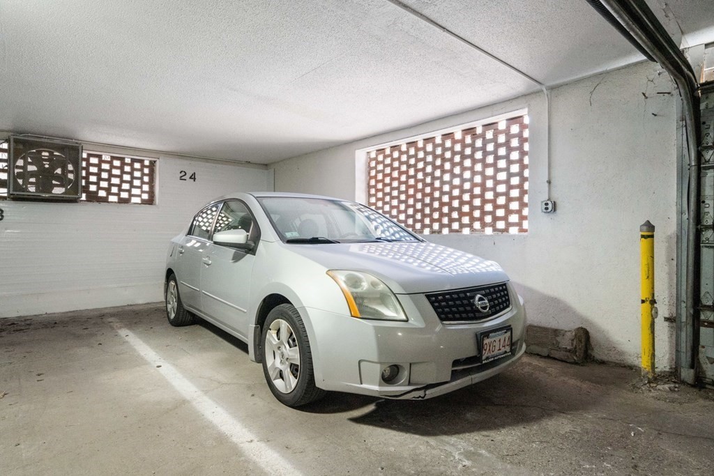 474 Broadway, Unit 49 Somerville, MA 02145 - Photo 15 of 19 a car that is parked in a garage