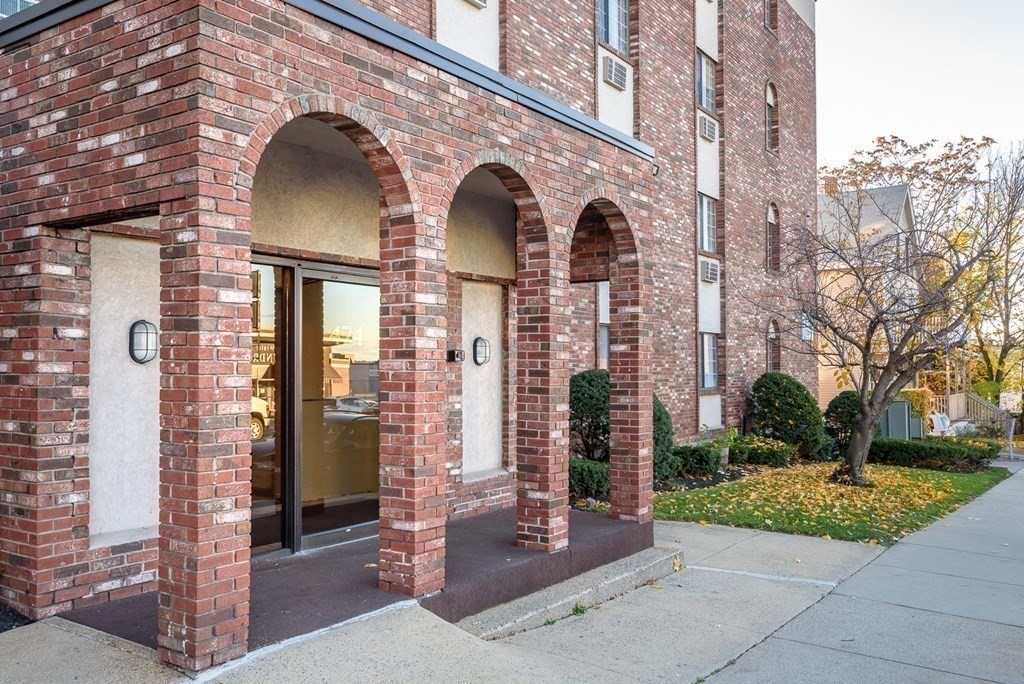 474 Broadway, Unit 49 Somerville, MA 02145 - Photo 18 of 19 a front view of a house with garden