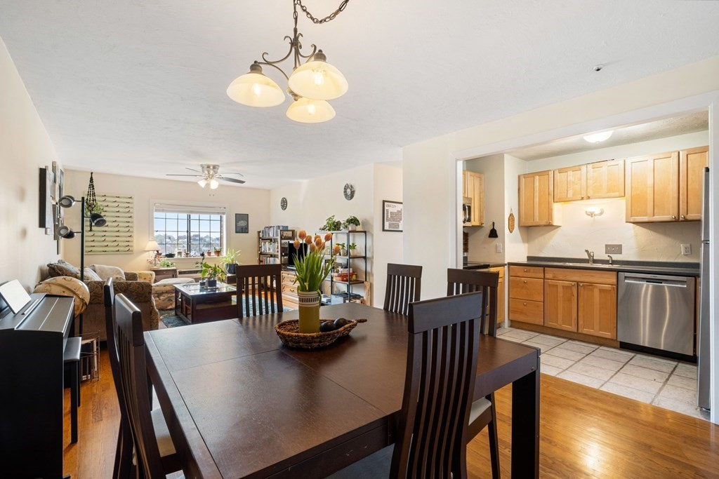 474 Broadway, Unit 49 Somerville, MA 02145 - Photo 3 of 19 a view of a dining room and livingroom with furniture wooden floor and a chandelier