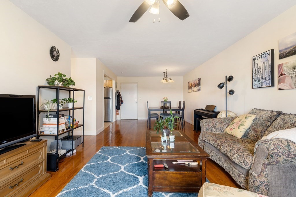 474 Broadway, Unit 49 Somerville, MA 02145 - Photo 4 of 19 a living room with furniture and a flat screen tv