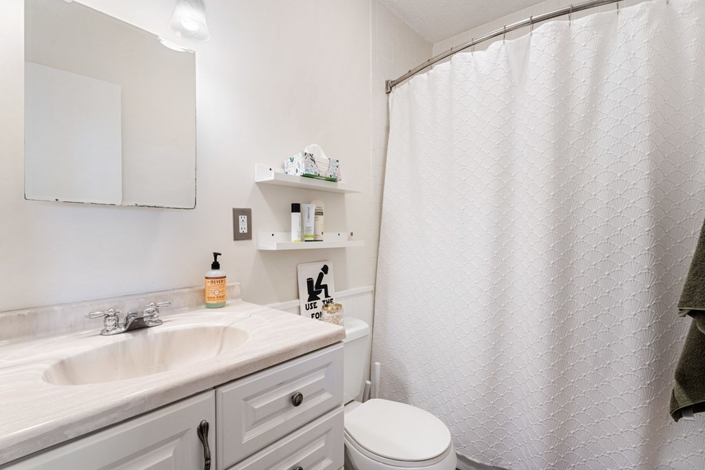 474 Broadway, Unit 49 Somerville, MA 02145 - Photo 8 of 19 a bathroom with a sink a toilet and a sink