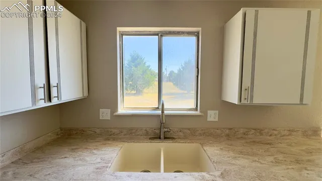 a bathroom with a sink and a window