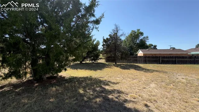 a view of a hallway with wooden floor and entryway