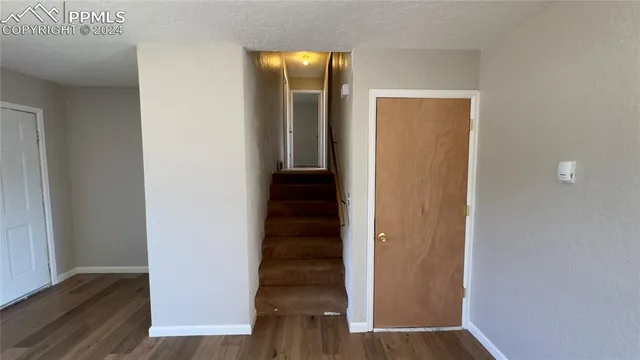 a bathroom with a granite countertop toilet and a sink