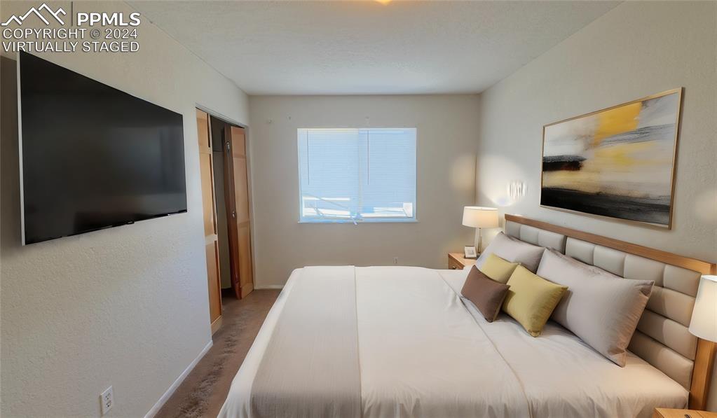 102 West 26th Street La Junta, CO 81050 - Photo 29 of 42 a bedroom with a bed and a flat screen tv