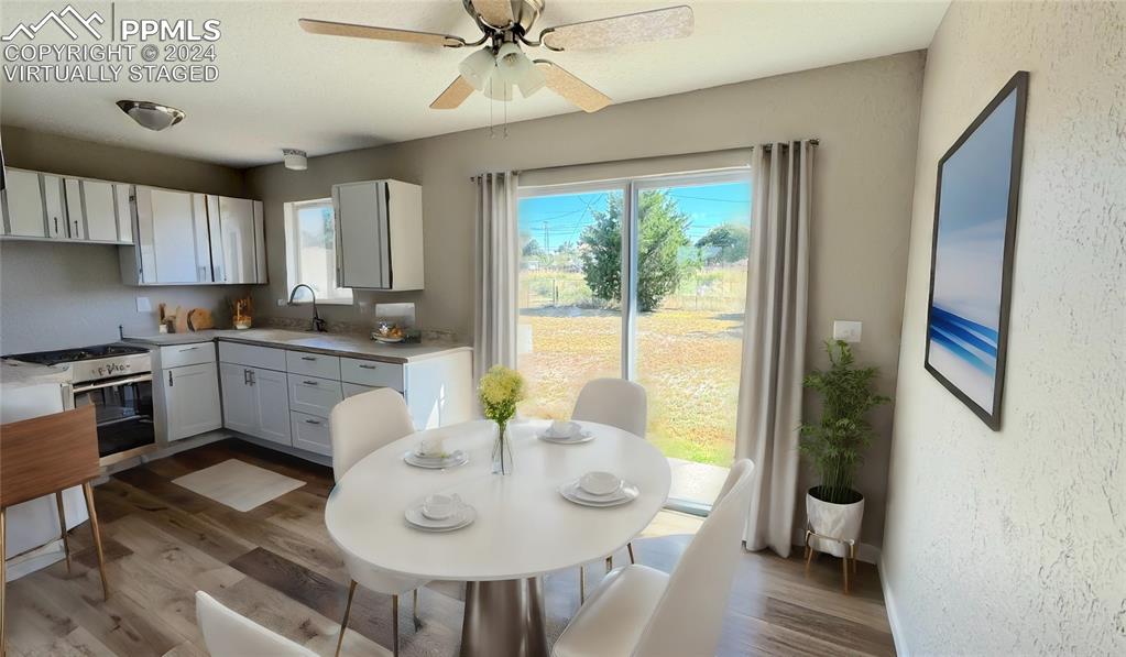 102 West 26th Street La Junta, CO 81050 - Photo 8 of 42 a kitchen with a table chairs sink and cabinets