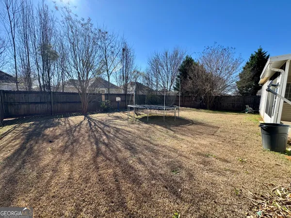 a swimming pool with wooden fence