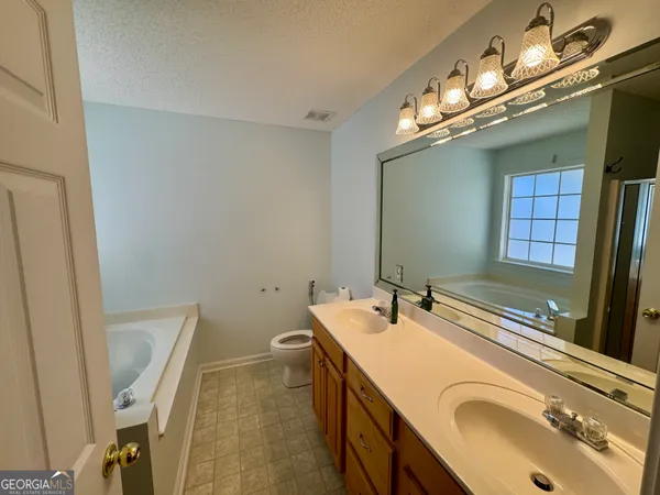 a bathroom with a sink a vanity and a mirror