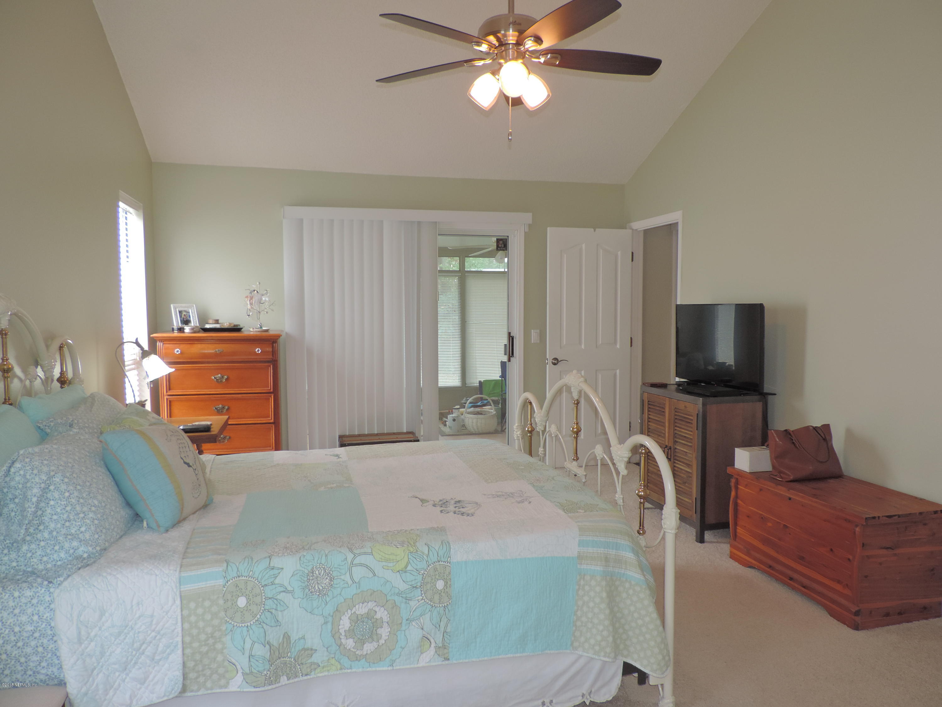 7024 St Augustine Road Jacksonville, FL 32217 - Photo 15 of 34 a bedroom with a bed and a flat screen tv