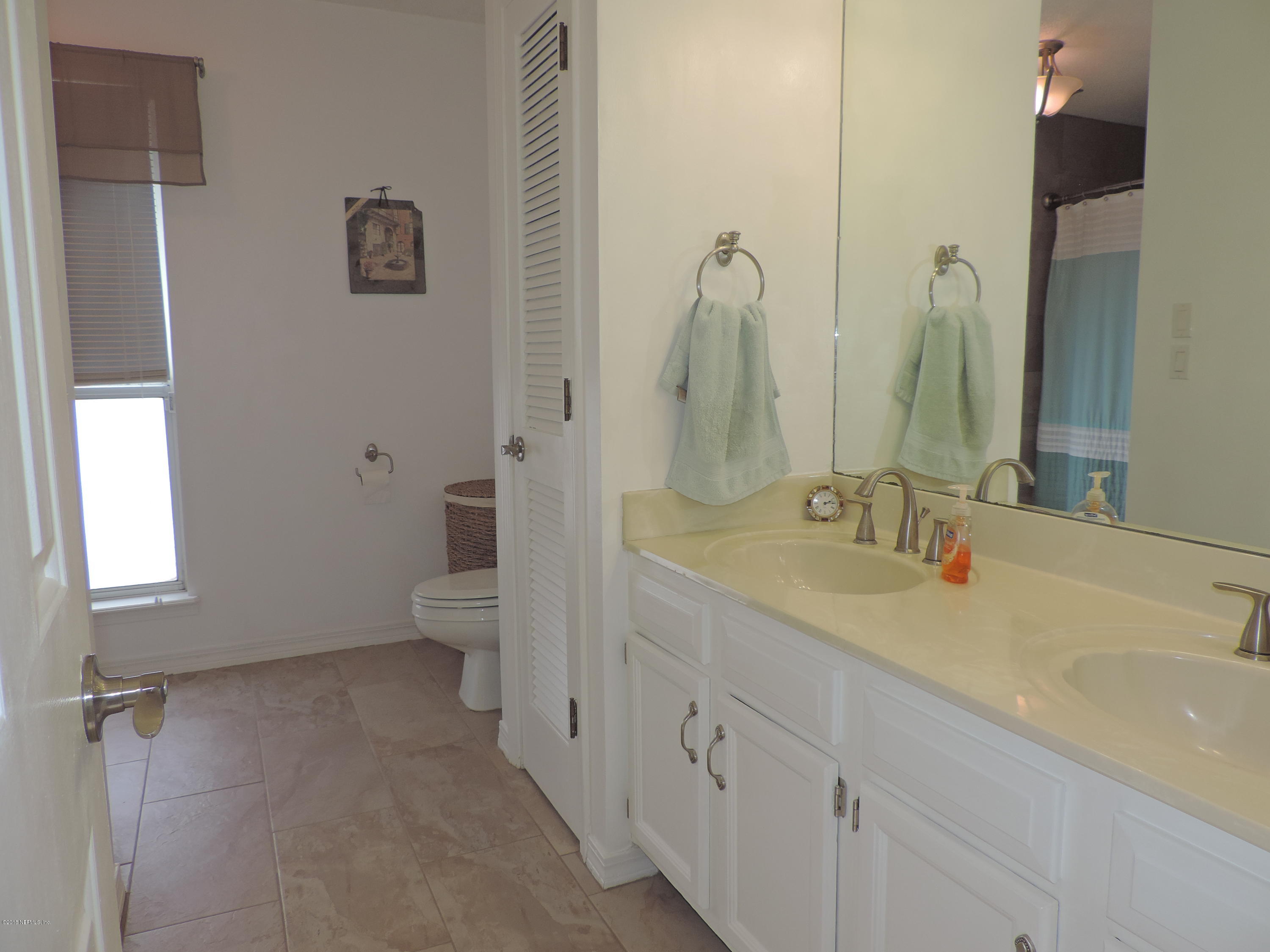 7024 St Augustine Road Jacksonville, FL 32217 - Photo 16 of 34 a bathroom with a double vanity sink toilet and a tub