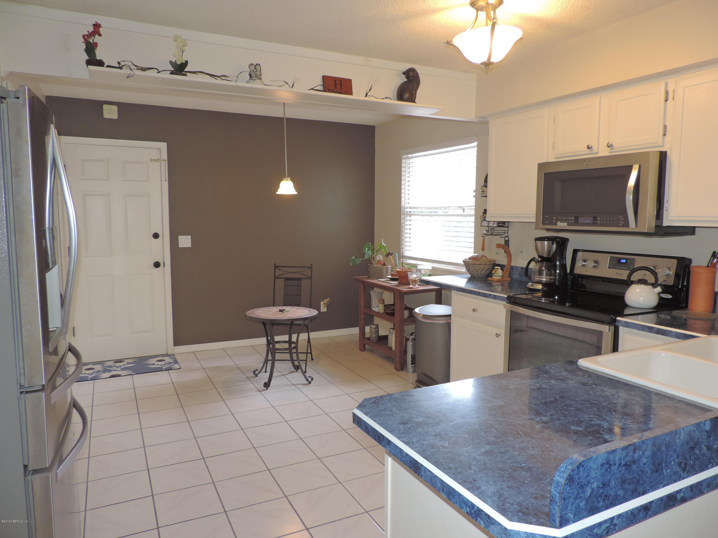 7024 St Augustine Road Jacksonville, FL 32217 - Photo 23 of 34 a kitchen with a sink a counter top space and stainless steel appliances