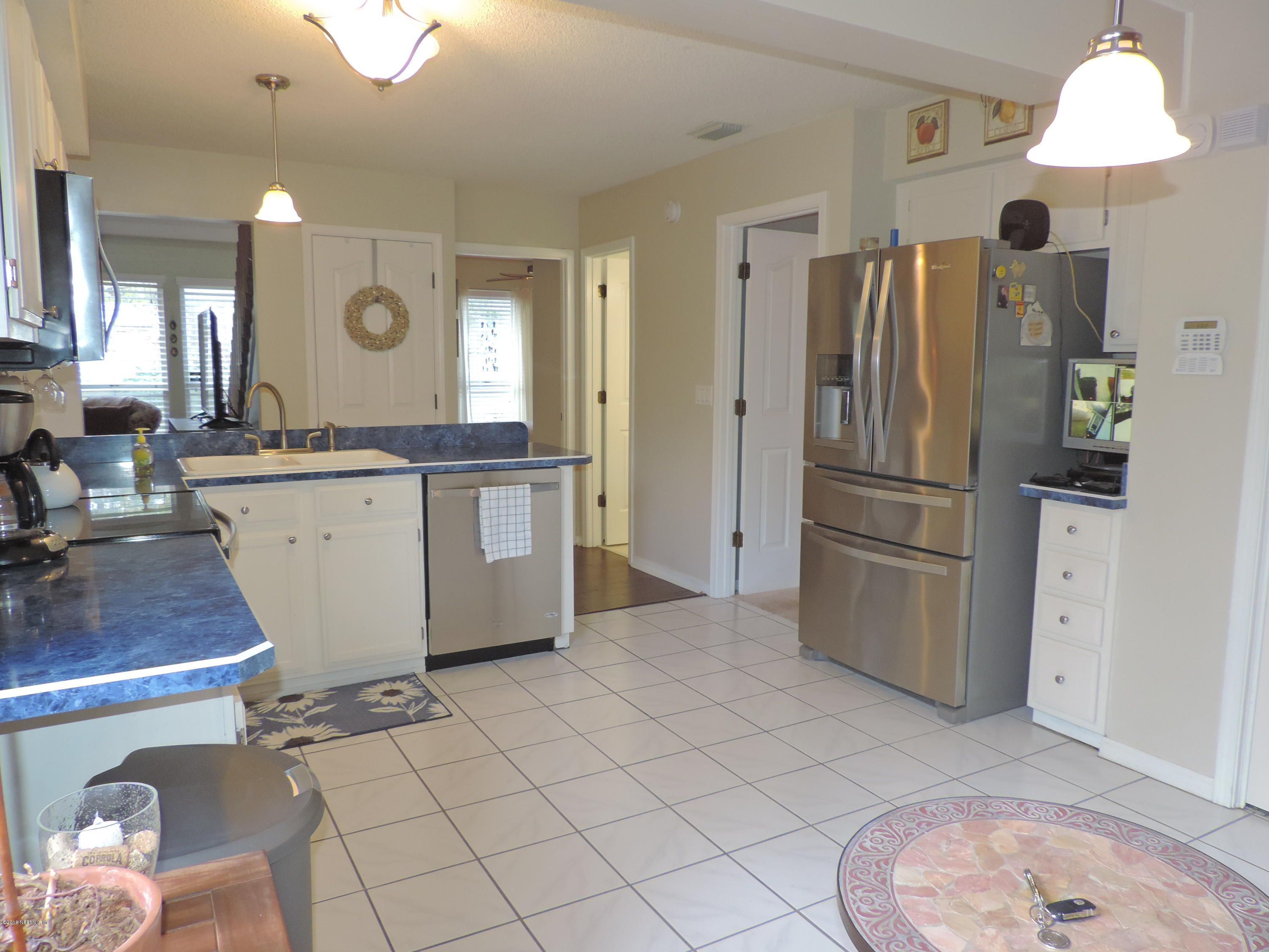 7024 St Augustine Road Jacksonville, FL 32217 - Photo 25 of 34 a kitchen with stainless steel appliances a refrigerator sink and cabinets