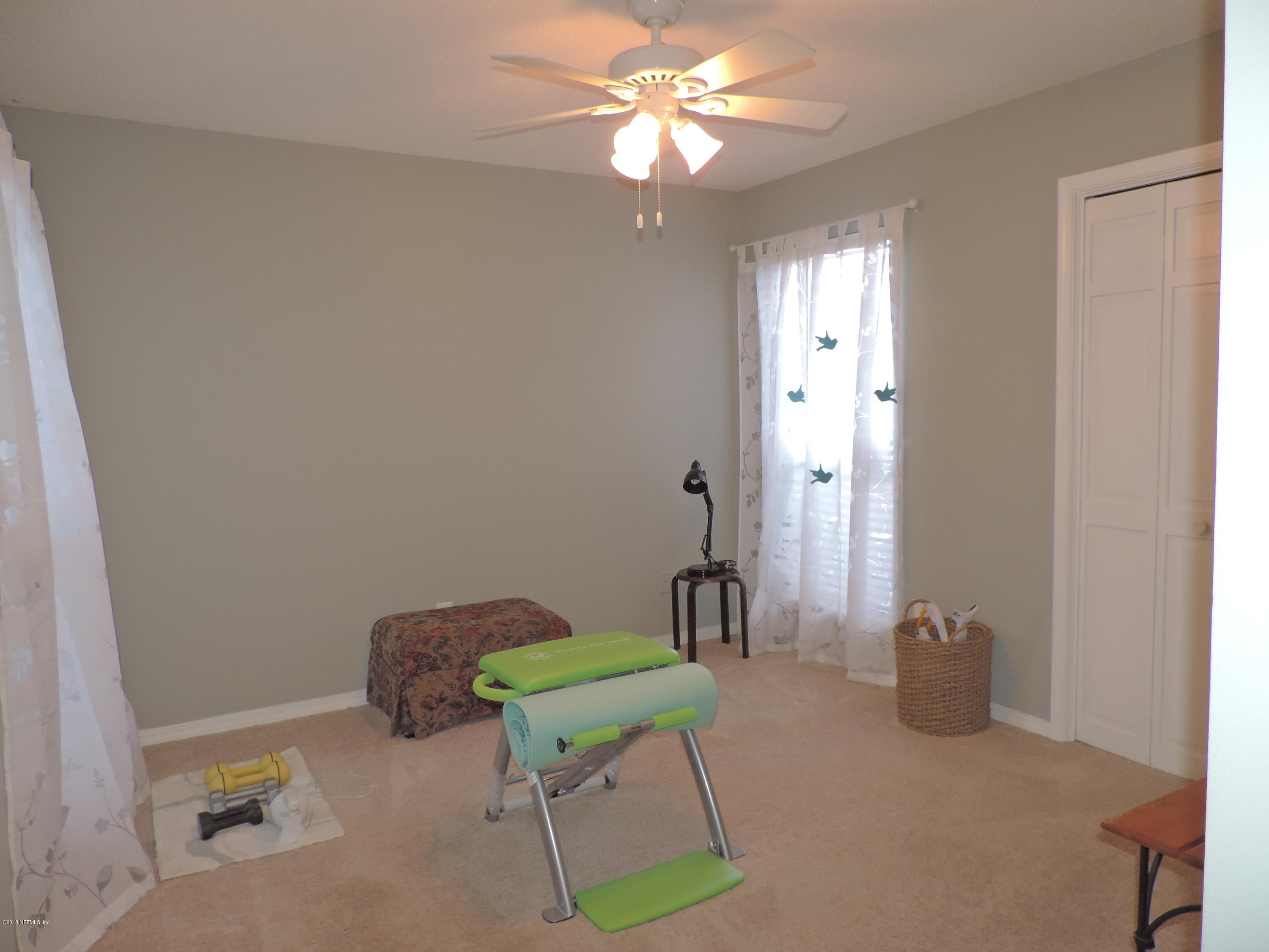 7024 St Augustine Road Jacksonville, FL 32217 - Photo 28 of 34 a bedroom with a bed and a chandelier