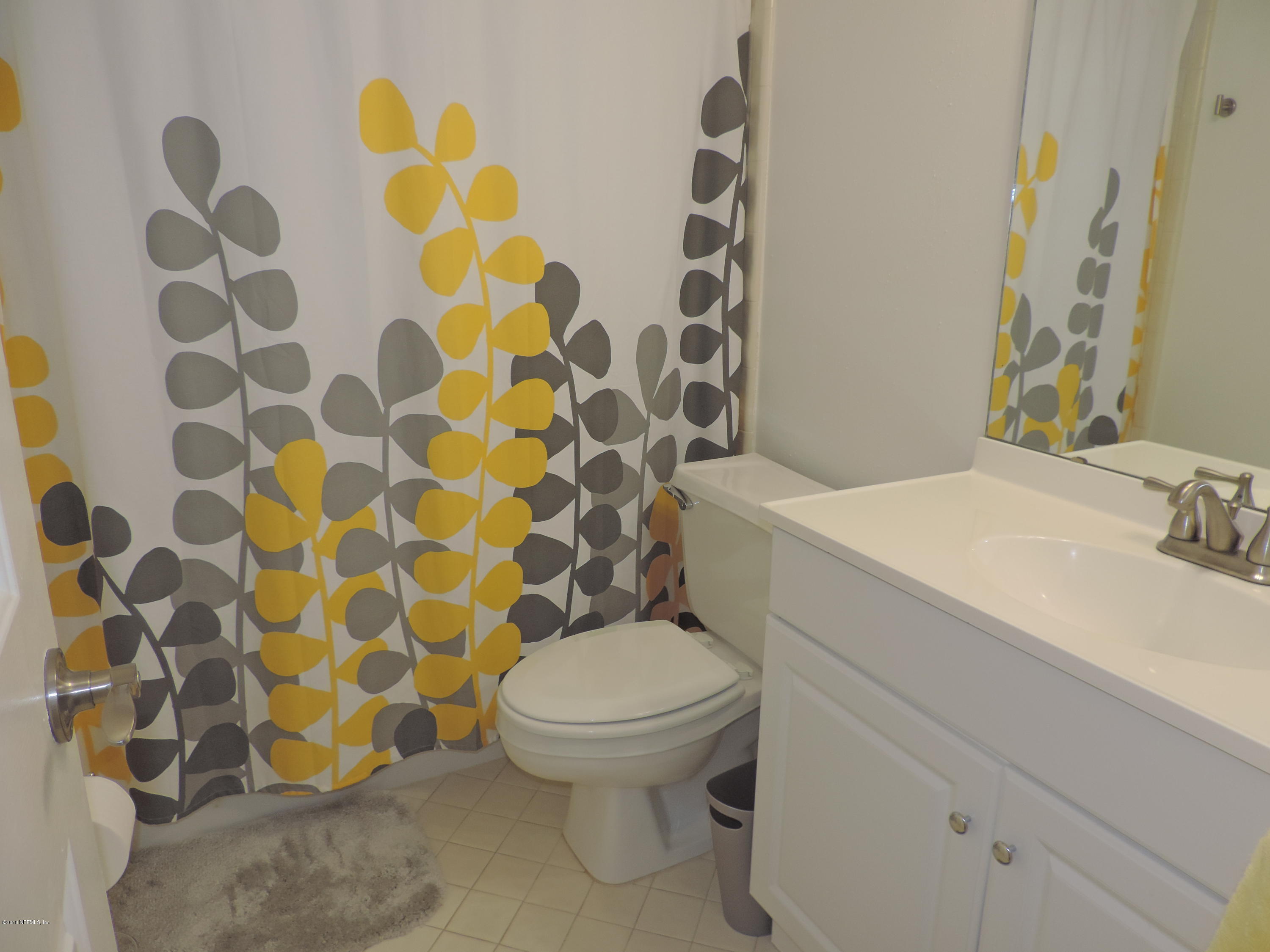 7024 St Augustine Road Jacksonville, FL 32217 - Photo 29 of 34 a bathroom with a sink and mirror with toilet