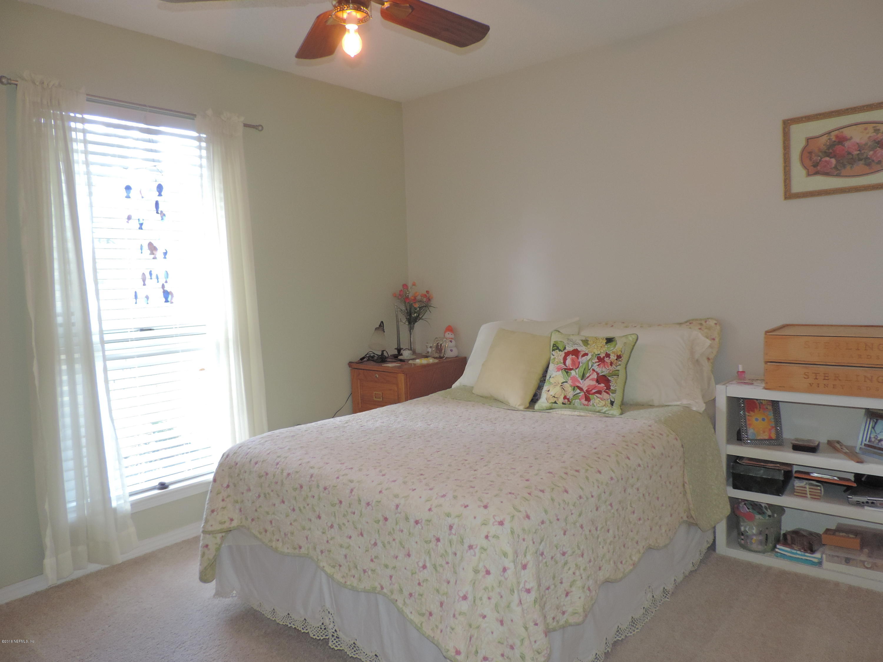 7024 St Augustine Road Jacksonville, FL 32217 - Photo 30 of 34 a bedroom with a bed and a chandelier