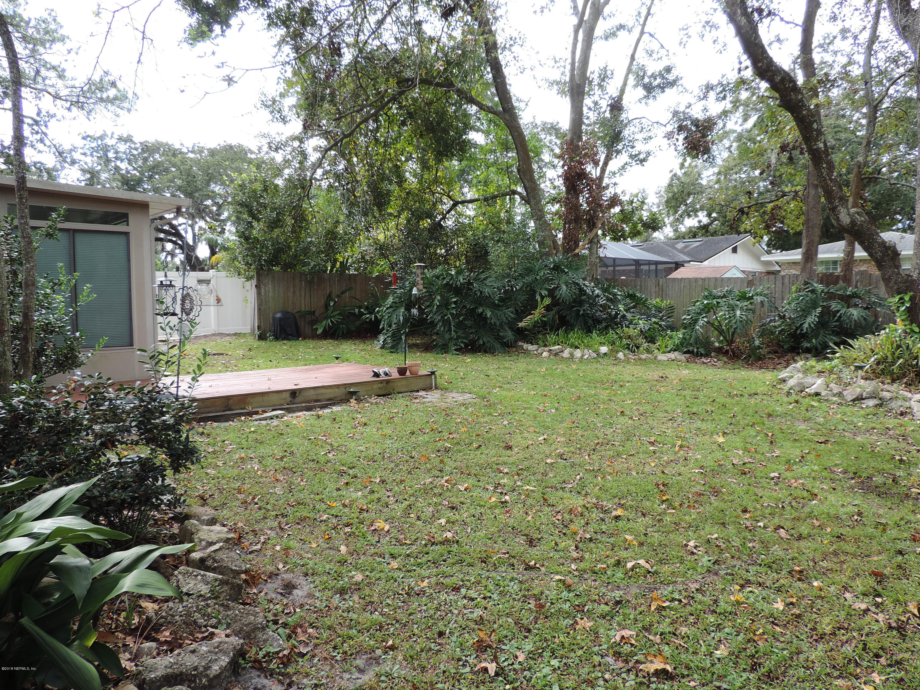 7024 St Augustine Road Jacksonville, FL 32217 - Photo 31 of 34 a backyard of a house with lots of green space