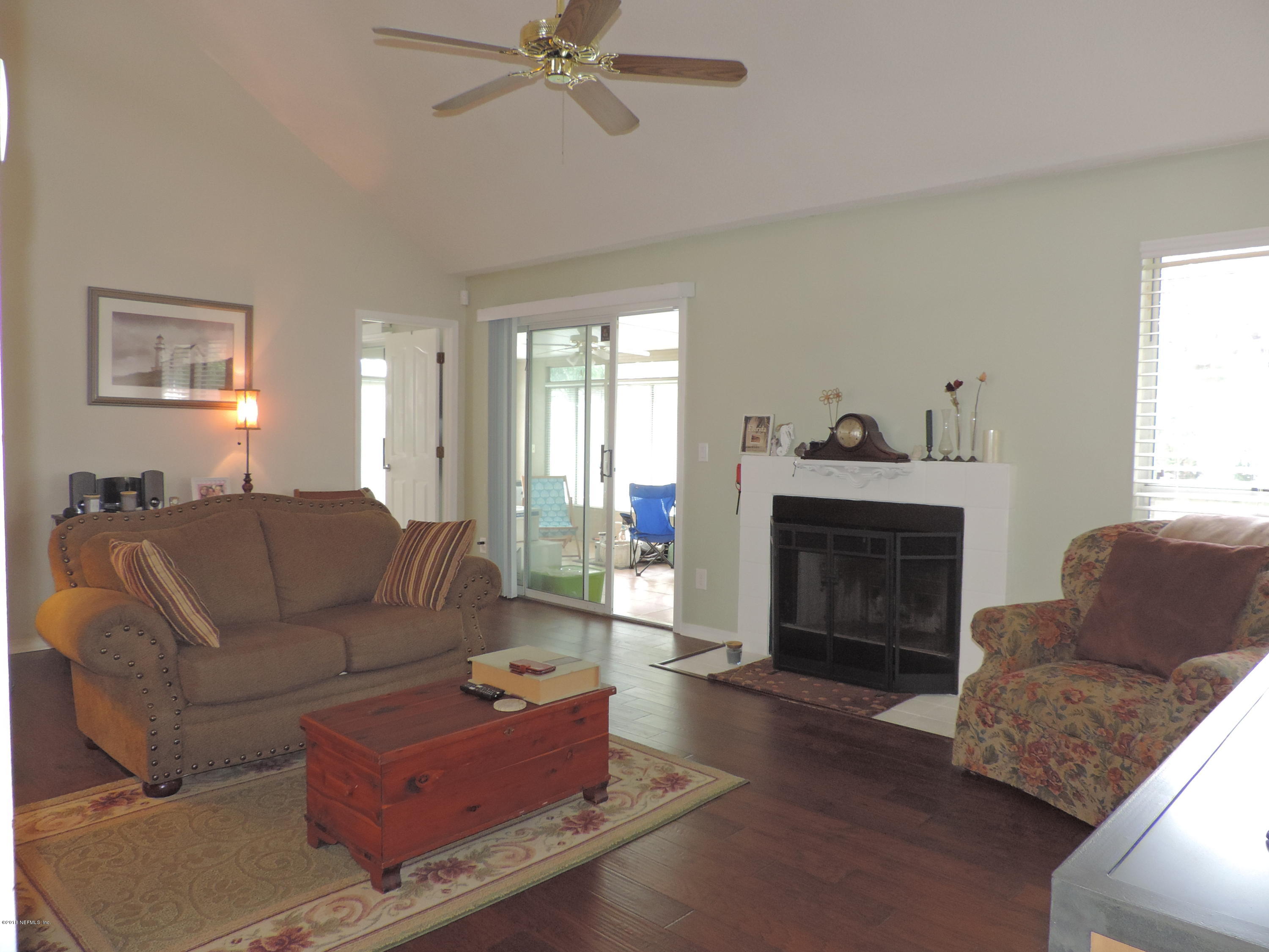 7024 St Augustine Road Jacksonville, FL 32217 - Photo 4 of 34 a living room with furniture and a fireplace
