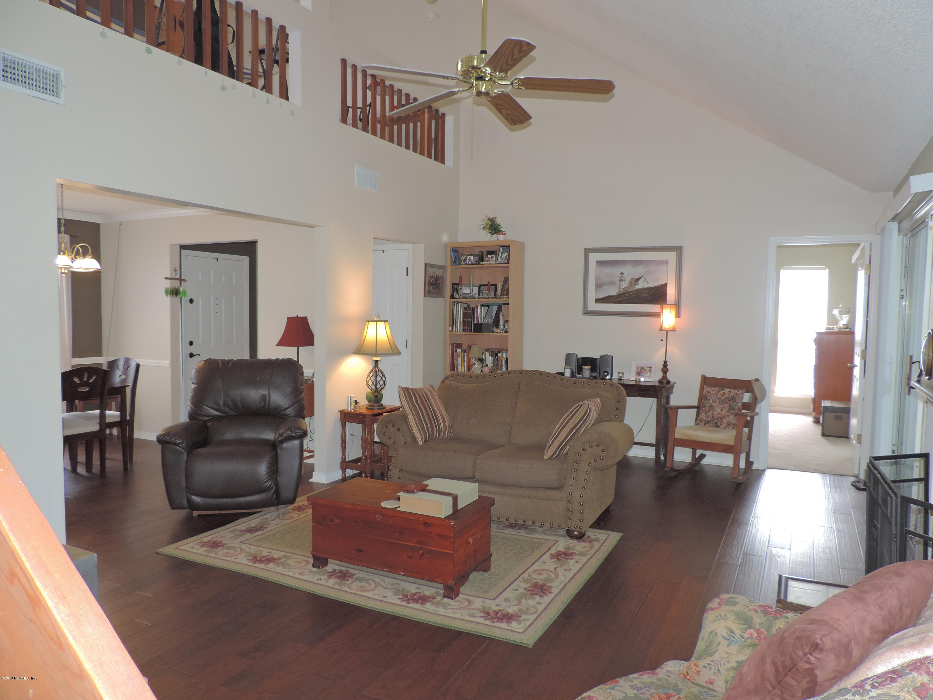 7024 St Augustine Road Jacksonville, FL 32217 - Photo 5 of 34 a living room with furniture and a chandelier