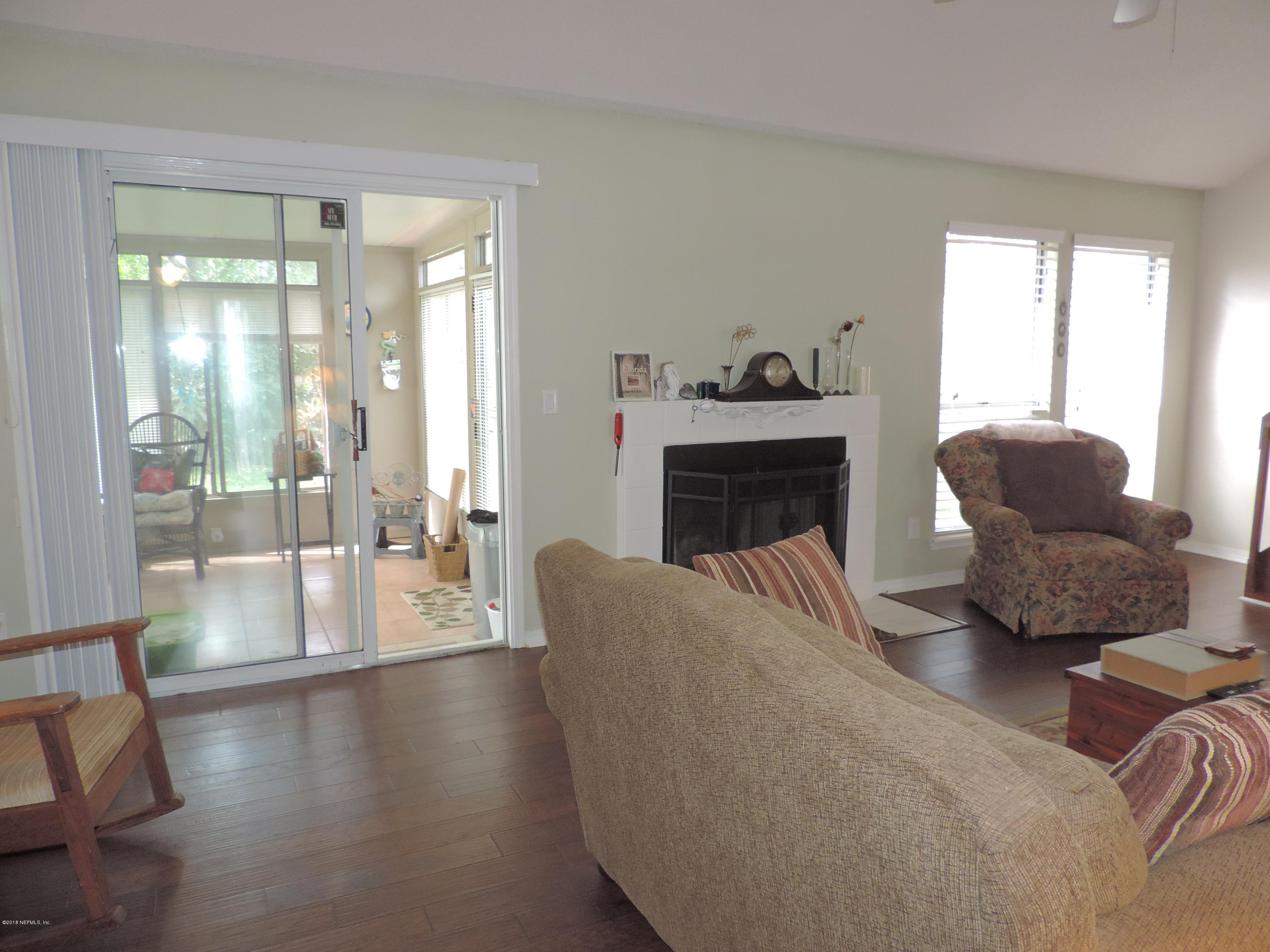7024 St Augustine Road Jacksonville, FL 32217 - Photo 6 of 34 a living room with furniture window and a fireplace