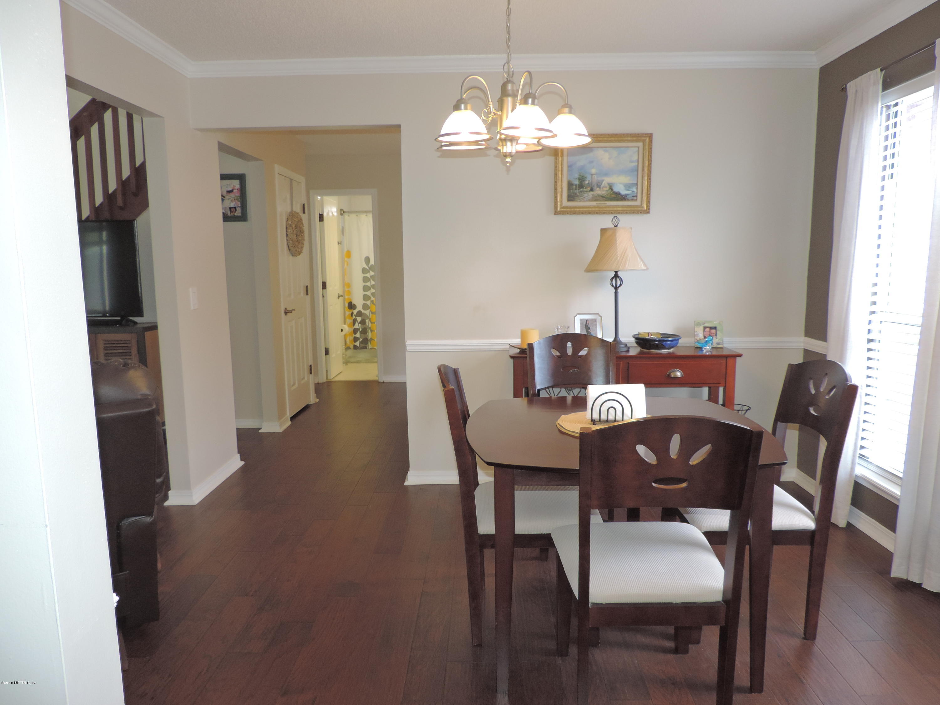 7024 St Augustine Road Jacksonville, FL 32217 - Photo 9 of 34 a view of a dining room with furniture and wooden floor