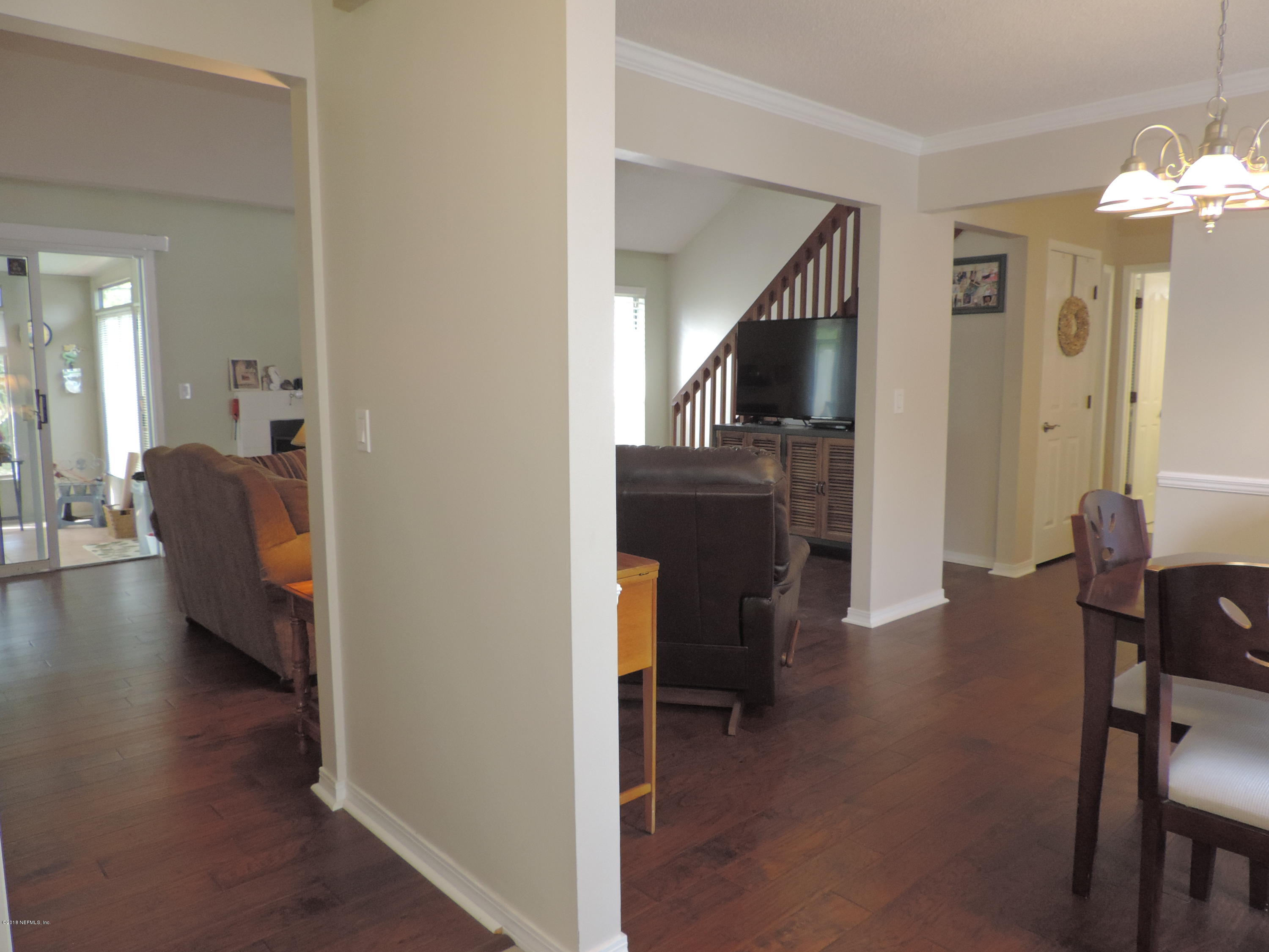 7024 St Augustine Road Jacksonville, FL 32217 - Photo 10 of 34 a view of a livingroom with furniture and wooden floor