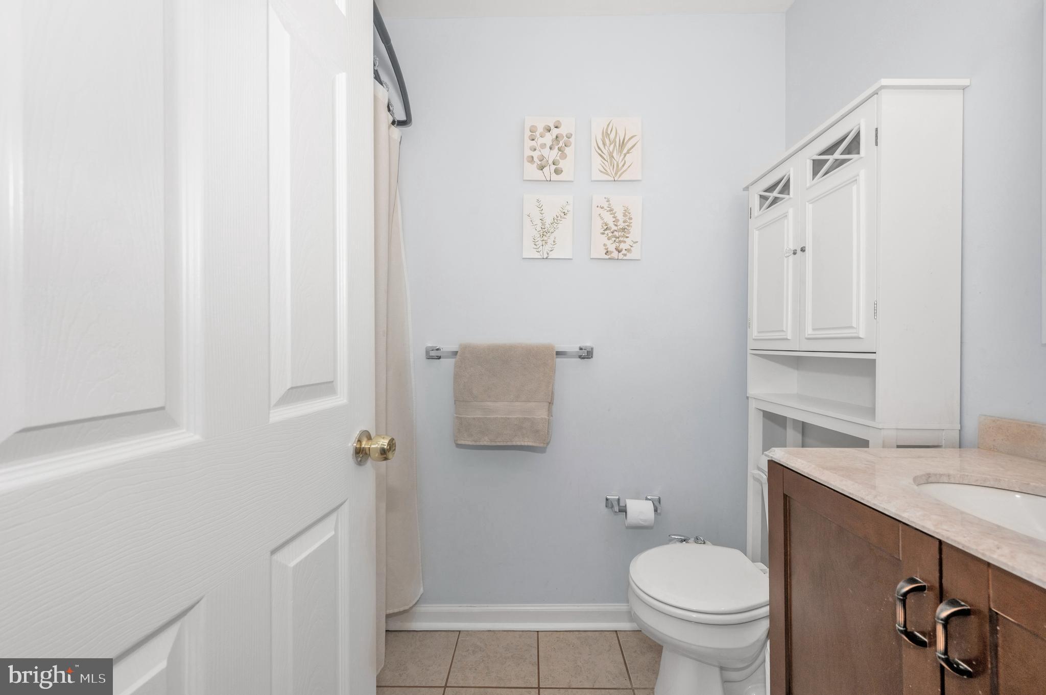 1107 2nd Avenue Brunswick, MD 21716 - Photo 26 of 52 a bathroom with a granite countertop sink toilet and a mirror