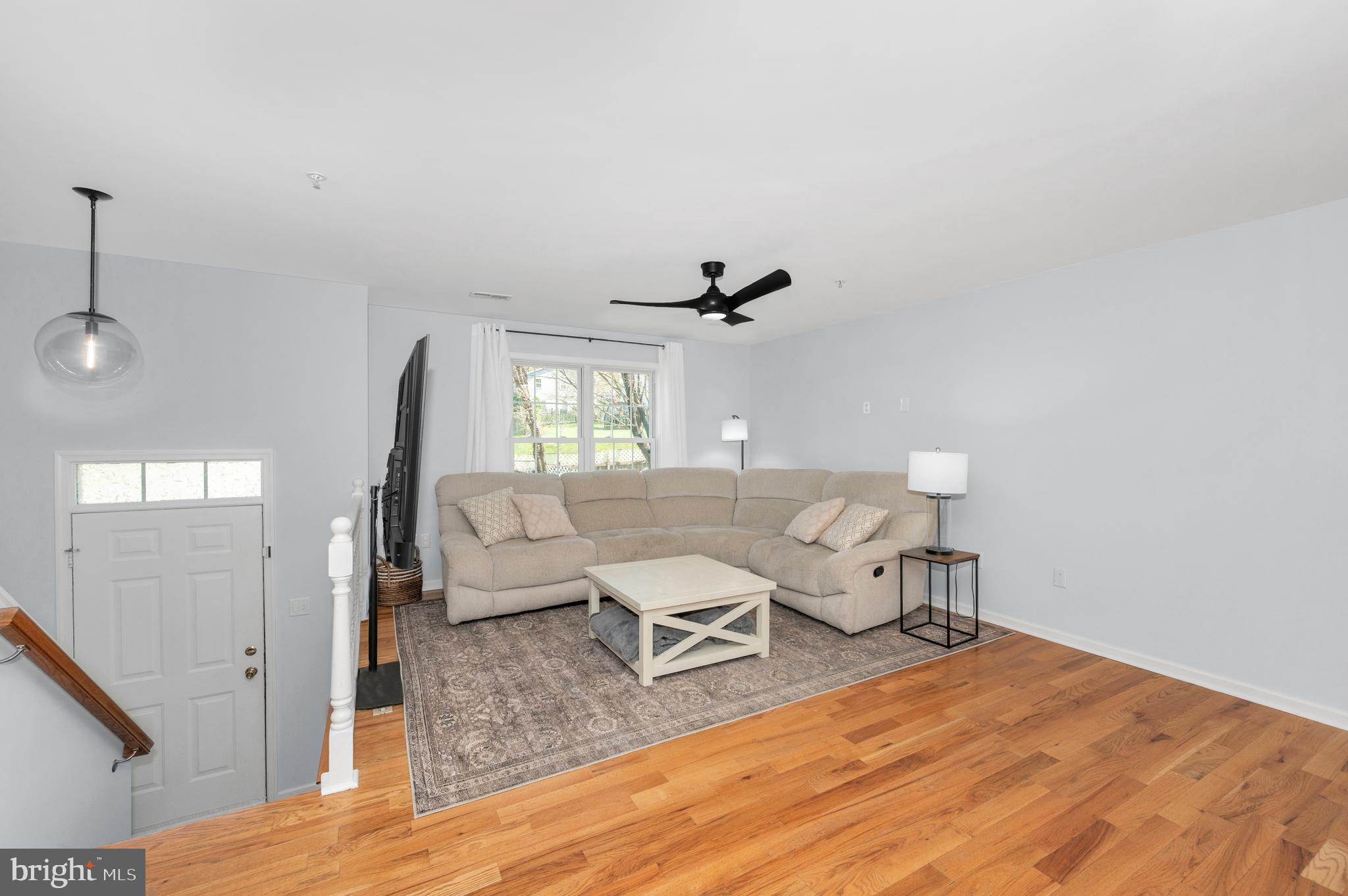 1107 2nd Avenue Brunswick, MD 21716 - Photo 3 of 52 a living room with couches chairs and closet with wooden floor