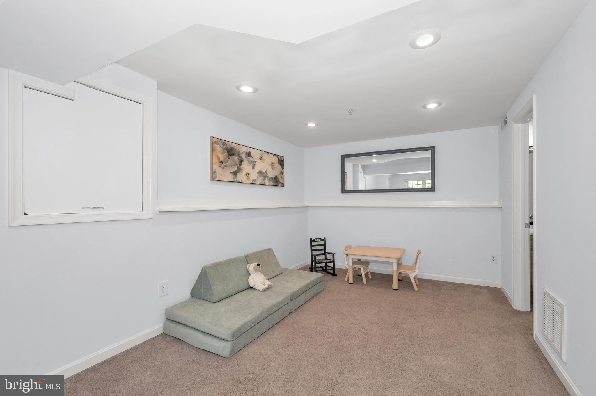 1107 2nd Avenue Brunswick, MD 21716 - Photo 33 of 52 a living room with furniture and a chair