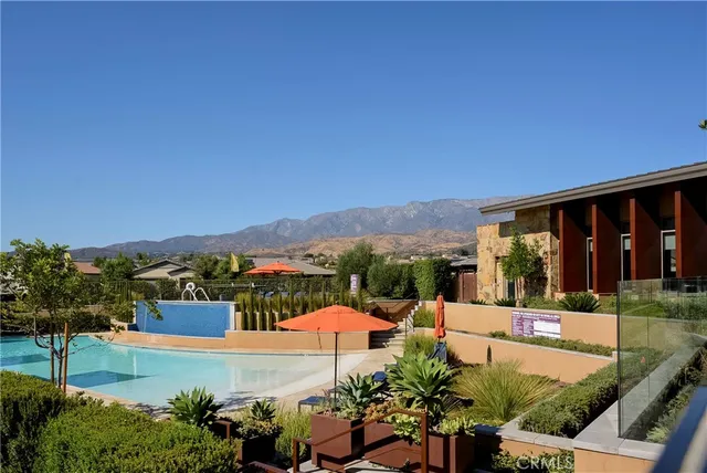 a view of a patio with couches table and chairs and potted plants