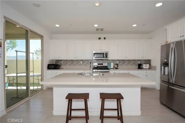 a kitchen with stainless steel appliances a sink and a refrigerator